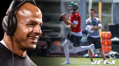 Zach Wilson gets ready to throw the ball in practice as NY Jets offensive coordinator Mike LaFleur looks on (with Robert Saleh).
