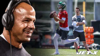 Zach Wilson gets ready to throw the ball in practice as NY Jets offensive coordinator Mike LaFleur looks on (with Robert Saleh).
