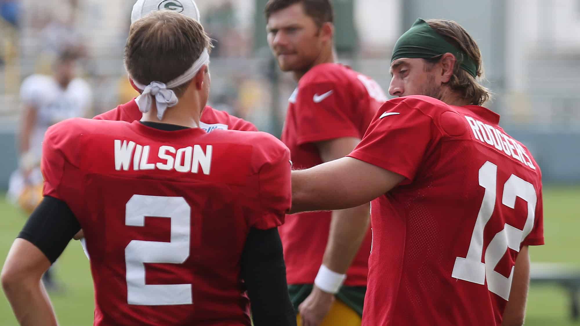 Zach Wilson talks to Aaron Rodgers ahead of a preseason game between the NY Jets and Green Bay Packers.