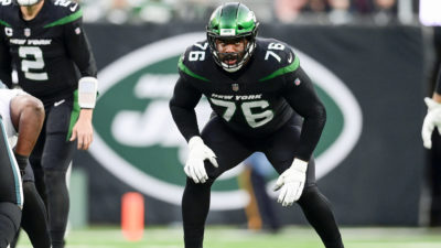 EAST RUTHERFORD, NEW JERSEY - DECEMBER 05: George Fant #76 of the New York Jets lines up against the Philadelphia Eagles at MetLife Stadium on December 05, 2021 in East Rutherford, New Jersey.