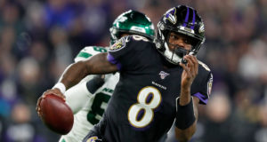 BALTIMORE, MARYLAND - DECEMBER 12: Quarterback Lamar Jackson #8 of the Baltimore Ravens scrambles against the defense of the New York Jets during the game at M&T Bank Stadium on December 12, 2019 in Baltimore, Maryland.