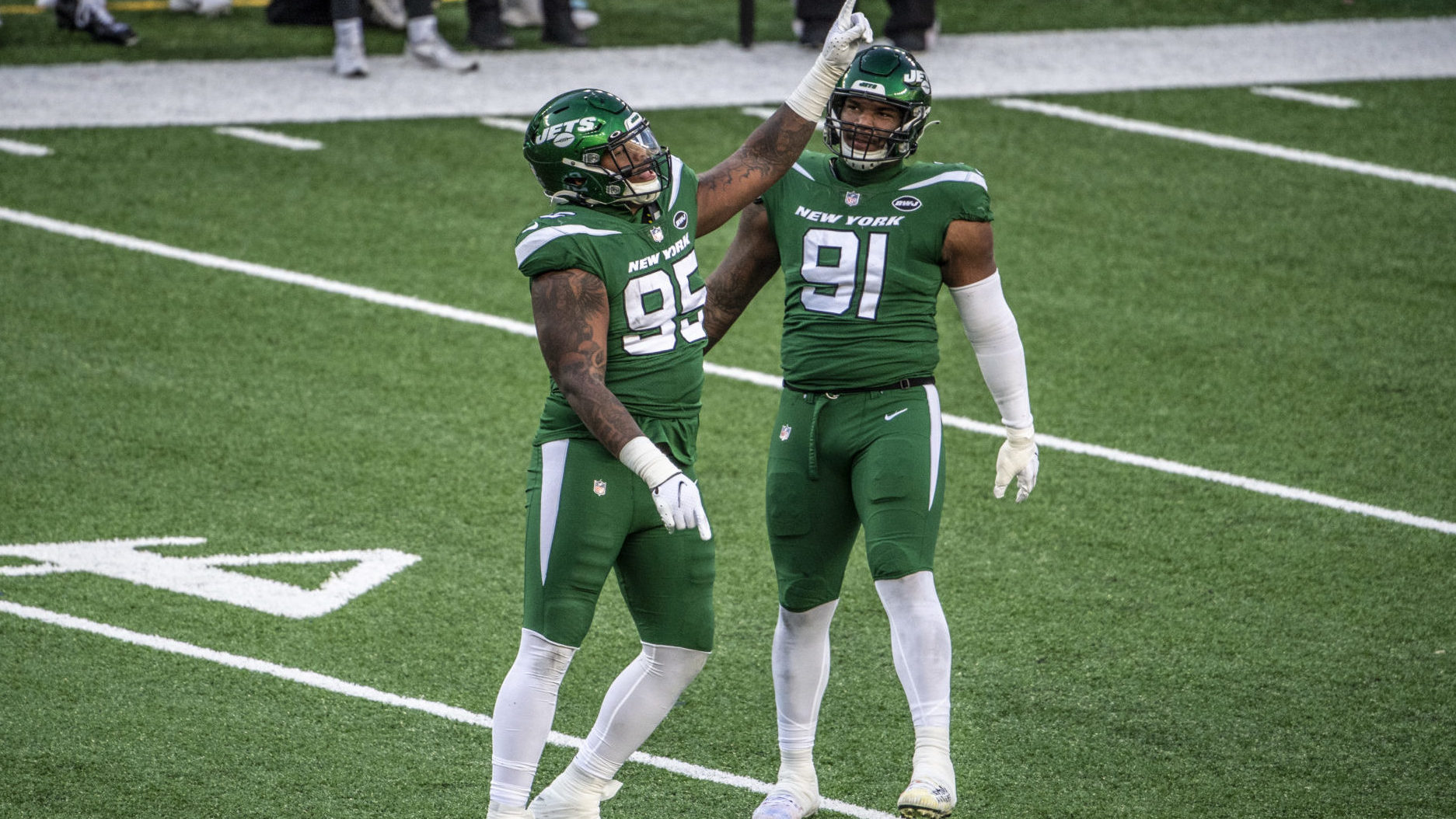 EAST RUTHERFORD, NJ - DECEMBER 06: Quinnen Williams #95 and John Franklin-Myers #91 of the New York Jets react during a regular season game against the Las Vegas Raiders at MetLife Stadium on December 6, 2020 in East Rutherford, New Jersey.
